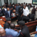 Vetting chaos forces venue change as tables, microphones are destroyed