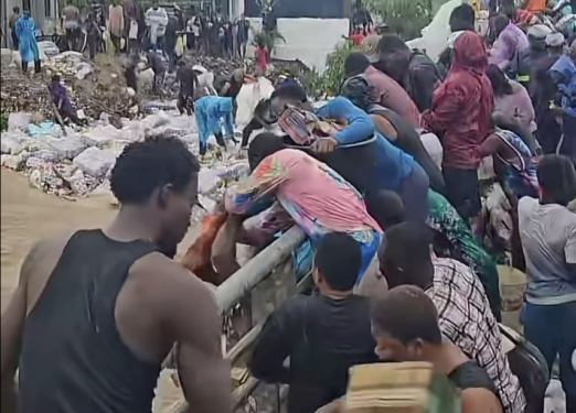 Residents Turn Flooded Gutters into ‘Shopping Aisles’ After Warehouse Cargo Is Swept Away by Rains
